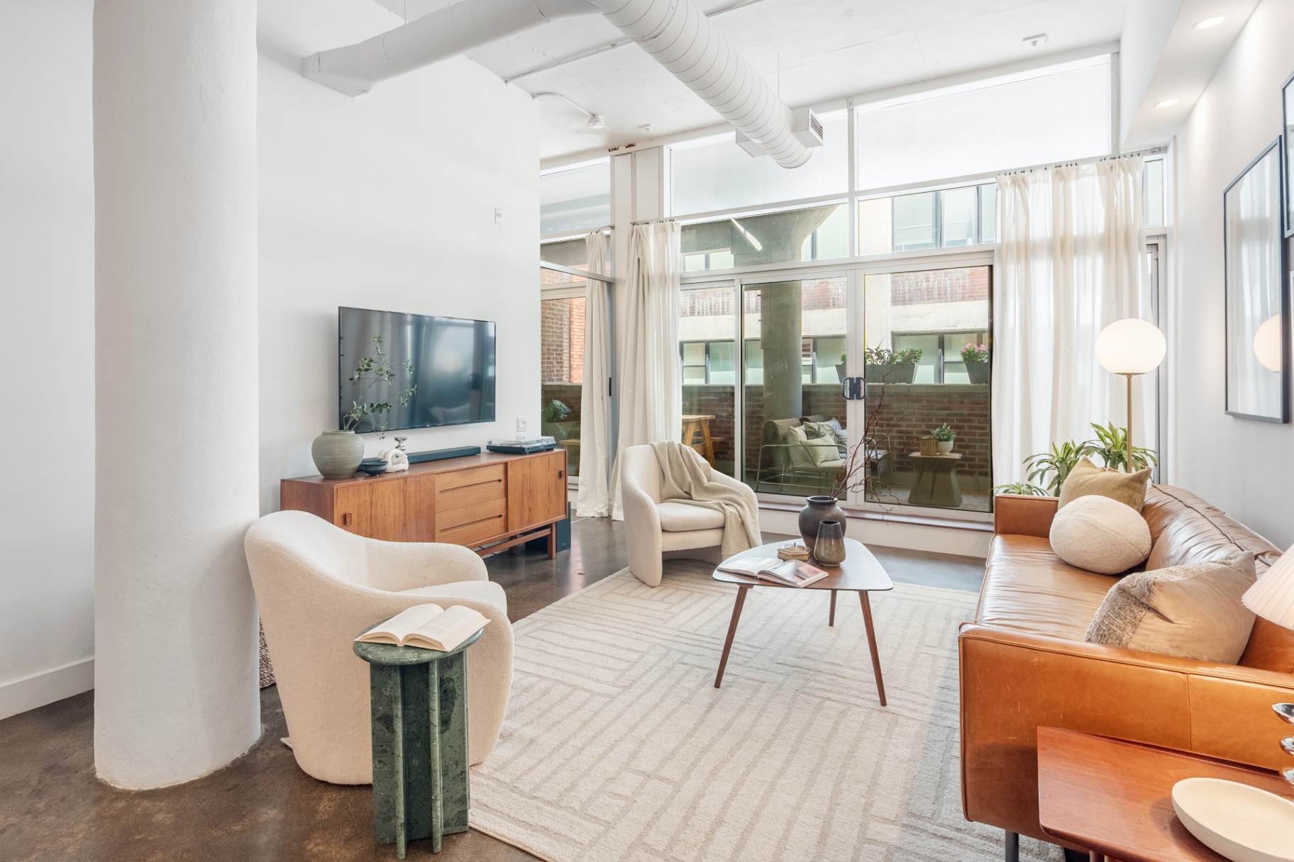 Living area with tv console and lounge chairs