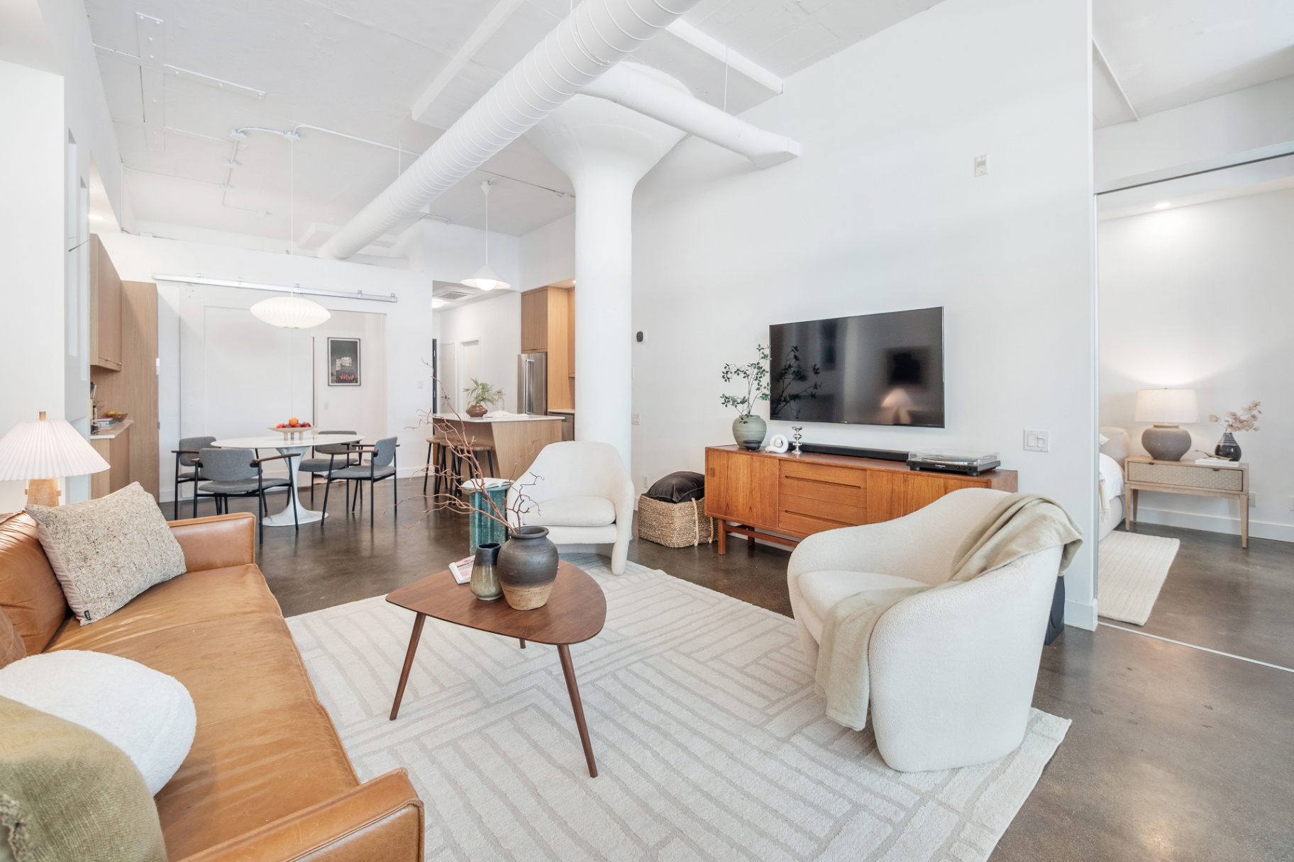 Living area with view to bedroom and kitchen