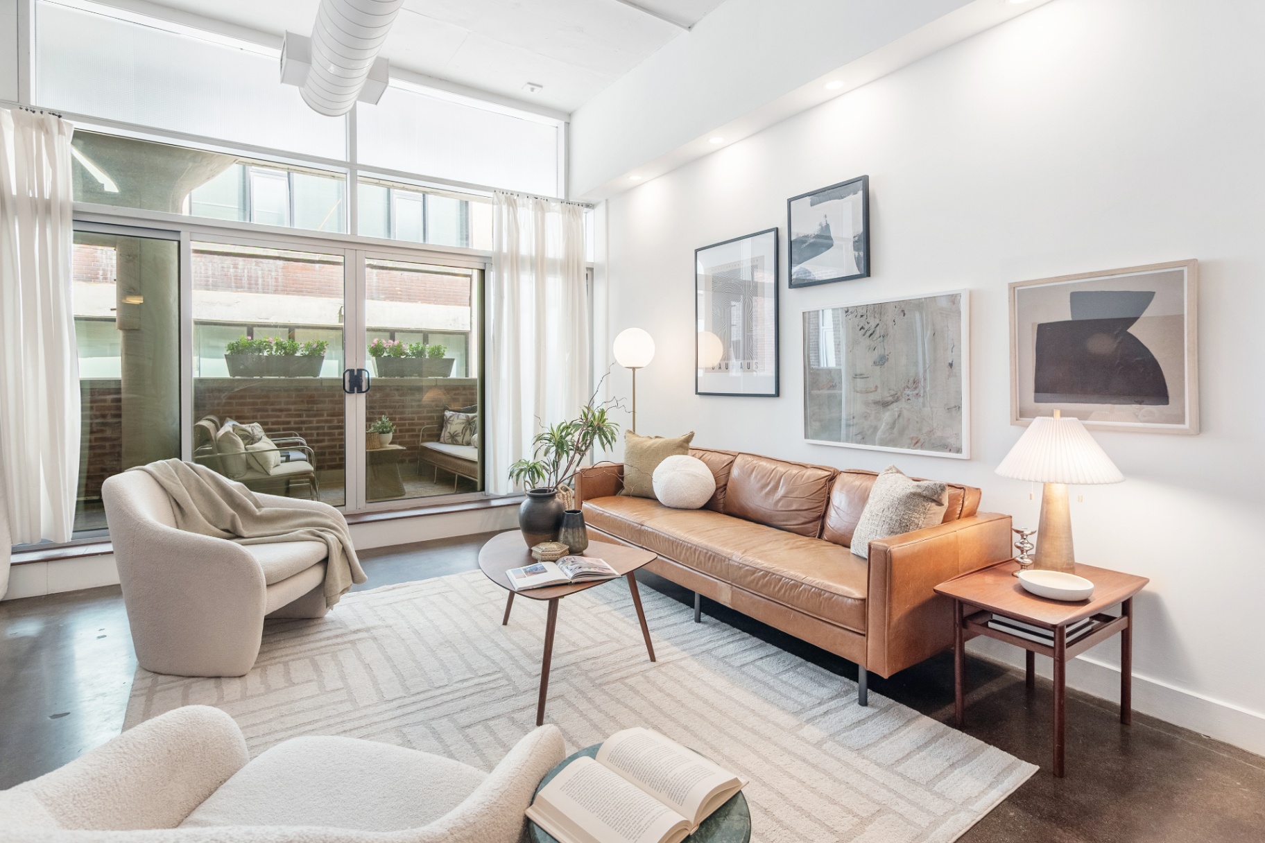 Living room with leather sofa and gallery wall