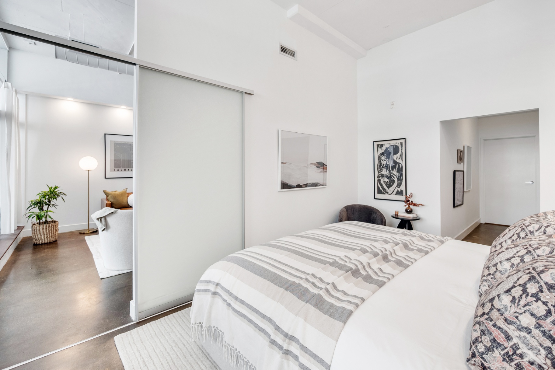 Primary bedroom with sliding door to living area