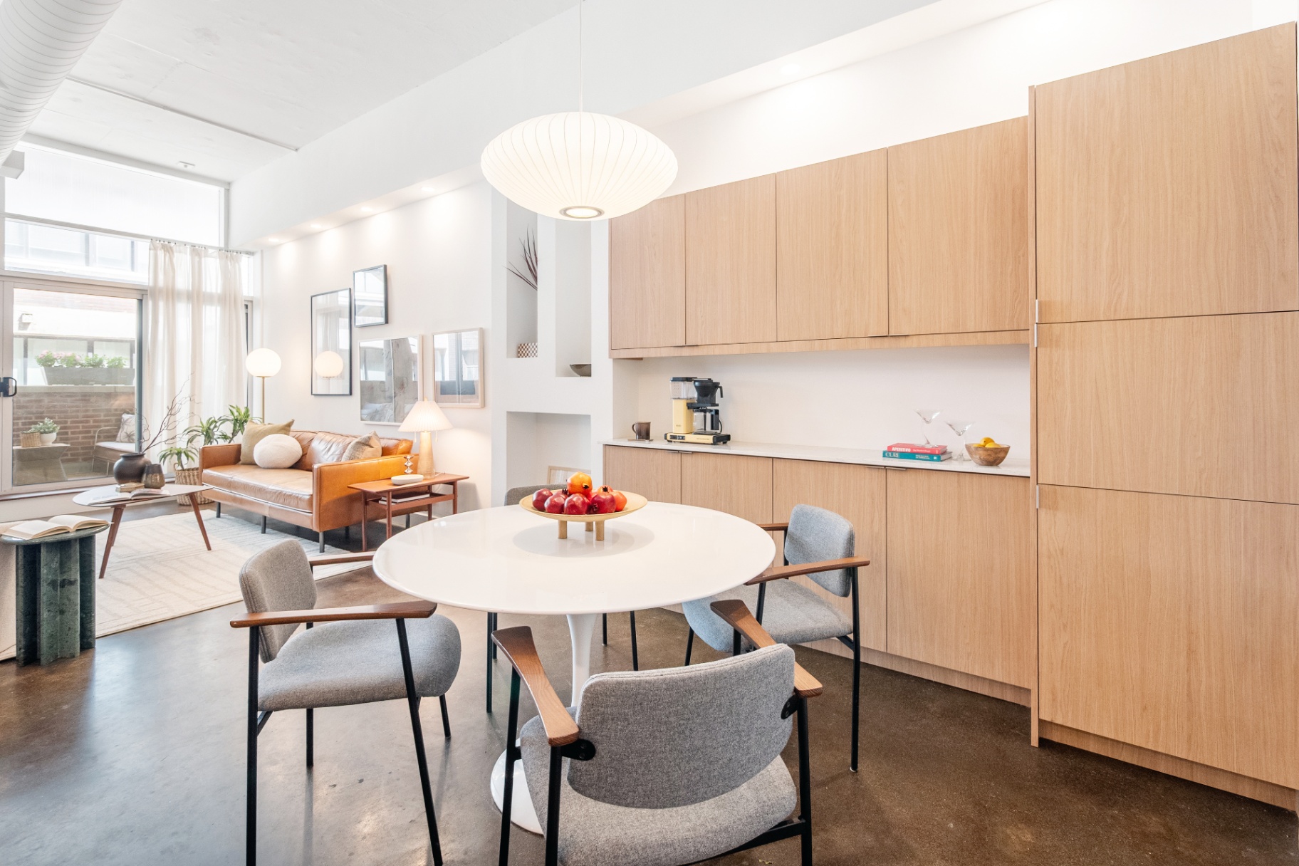 Dining area with pendant light and living room
